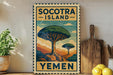 a vintage-style sign for Socotra Island, Yemen, with a colorful illustration of a tree and mountains. The sign is displayed on a wall, with a wooden cutting board and a potted plant to the left.