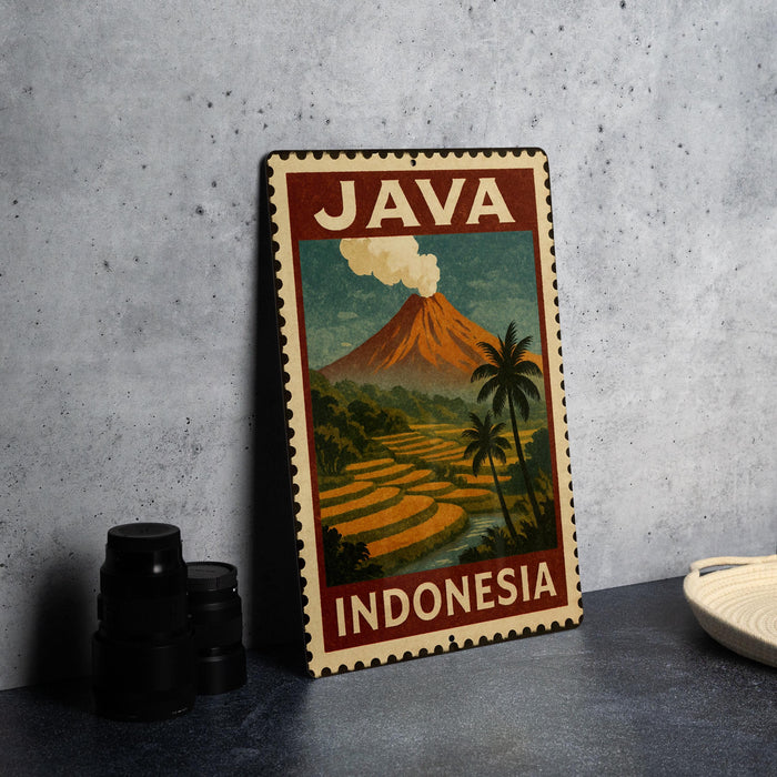 A vintage-style metal sign with the text "JAVA INDONESIA" and an illustration of a tropical landscape with a volcano, palm trees, and rice fields.