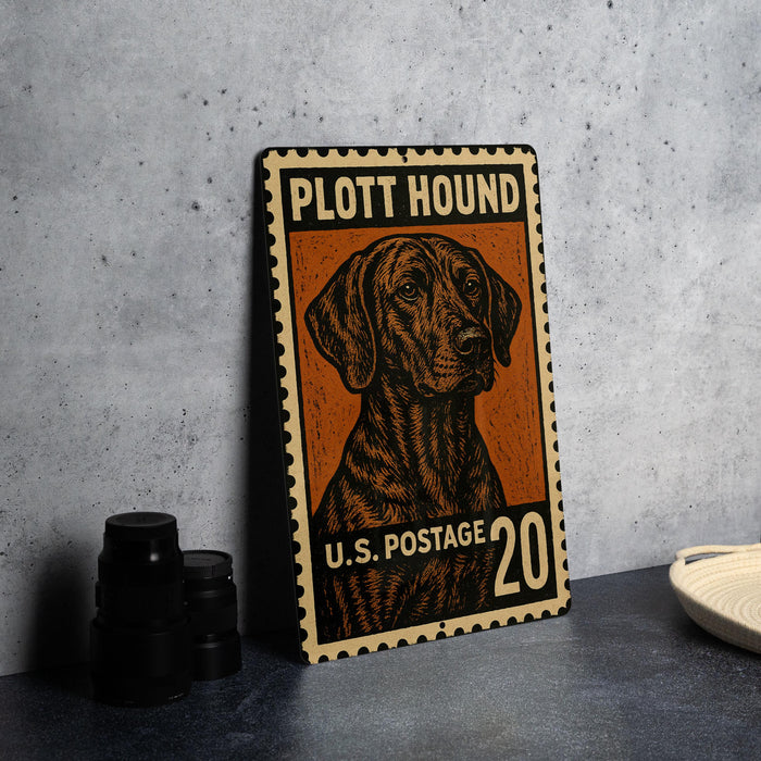 A metal stamp featuring a hound dog on a postcard-style background, with the text "PLOTT HOUND" and "U.S. POSTAGE 20" printed on it.