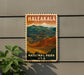 A vintage-style metal sign with the text "Haleakala National Park USA" displayed on a wall, featuring a scenic mountain landscape.