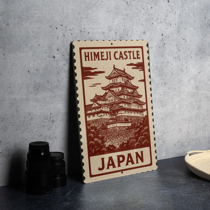A sign featuring the Himeji Castle in Japan, with a detailed illustration of the castle on it.