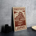 A sign featuring the Himeji Castle in Japan, with a detailed illustration of the castle on it.