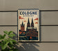 A vintage-style metal sign with the text "COLOGNE GERMANY" and an illustration of the Cologne Cathedral, a famous landmark in Germany.