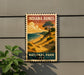 A vintage-style sign for Indiana Dunes National Park, featuring a scenic landscape with a beach, mountains, and a tree.