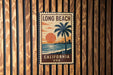 A vintage-style metal sign with the text "LONG BEACH CALIFORNIA USA" is displayed on a wooden wall.