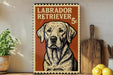 A vintage-style metal sign featuring a Labrador Retriever dog, with the text "LABRADOR RETRIEVER 5c" printed on it. The sign is displayed on a shelf next to a wooden cutting board and some kitchen utensils.