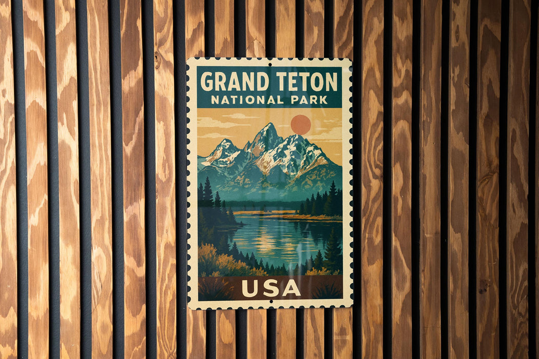 A vintage postage stamp featuring a scenic landscape with mountains, a lake, and pine trees, with the text "GRAND Teton NATIONAL PARK USA" displayed prominently.