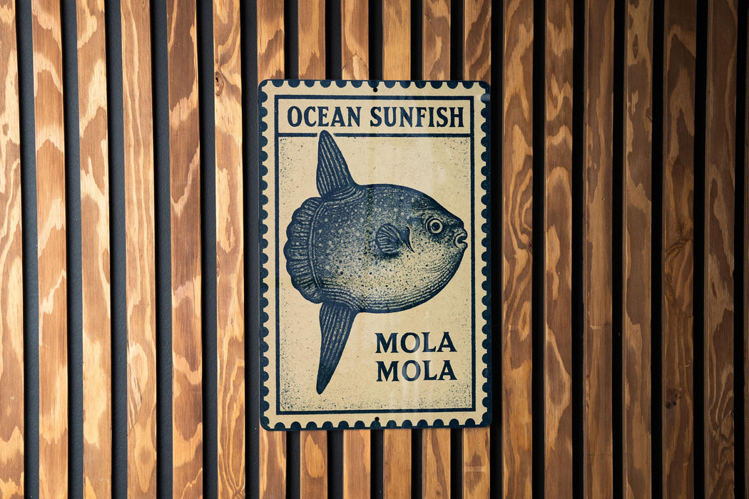 a blue and white sign with a picture of a fish, mounted on a wooden wall.
