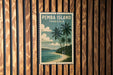 A vintage-style postage stamp depicting a tropical beach scene with palm trees and a blue sky, hanging on a wooden wall.