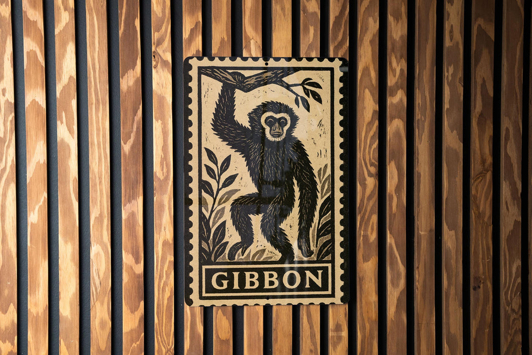 A framed illustration of a monkey is displayed on a wooden wall.