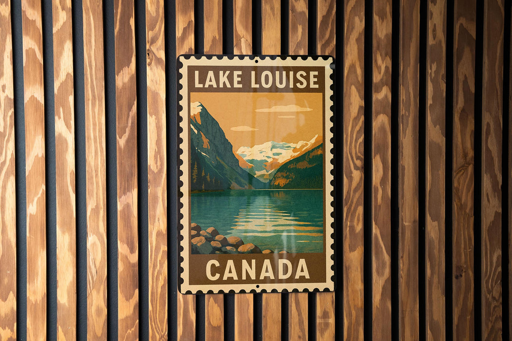 A vintage-style poster of Lake Louise, a famous Canadian landmark, is displayed on a wooden wall.