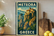 A vintage-style metal sign with the text "METEORA GREECE" and an illustration of a castle on a mountain.