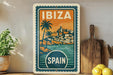 A vintage-style travel poster for Ibiza, Spain, featuring a tropical beach scene with palm trees and buildings.