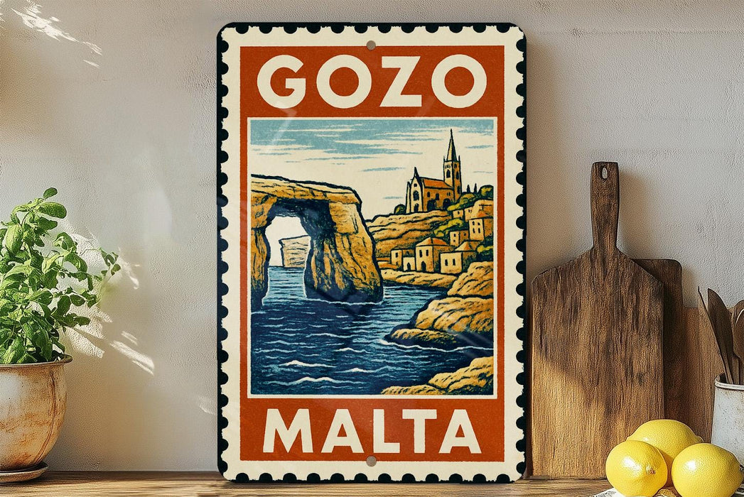 A vintage-style metal sign with the text "GOZO MALTA" and an illustration of a coastal town with a church spire, set against a backdrop of a rocky arch and a body of water.