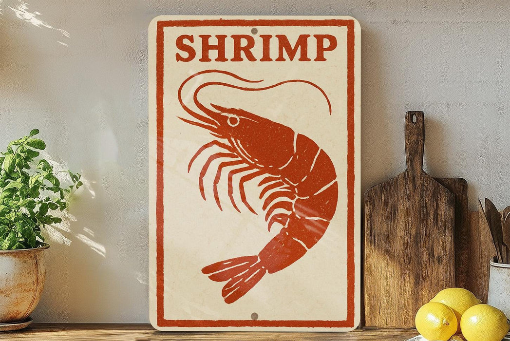 A sign with a red shrimp illustration is displayed on a shelf next to a wooden cutting board and some lemons.