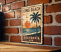 A vintage-style stamp or sign with the text "LONG BEACH CALIFORNIA USA" displayed on a brick wall.