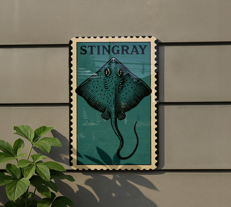 A framed image of a stingray is mounted on a wall, with a plant visible to the left.