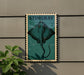 A framed image of a stingray is mounted on a wall, with a plant visible to the left.