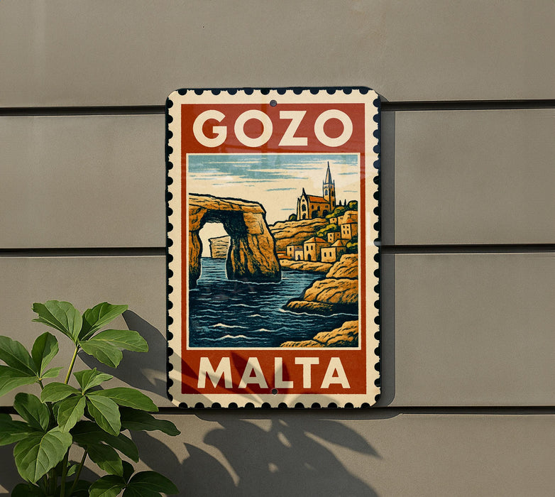 A vintage-style metal sign with a colorful illustration of a coastal town, featuring a castle, cliffs, and water, mounted on a wall.