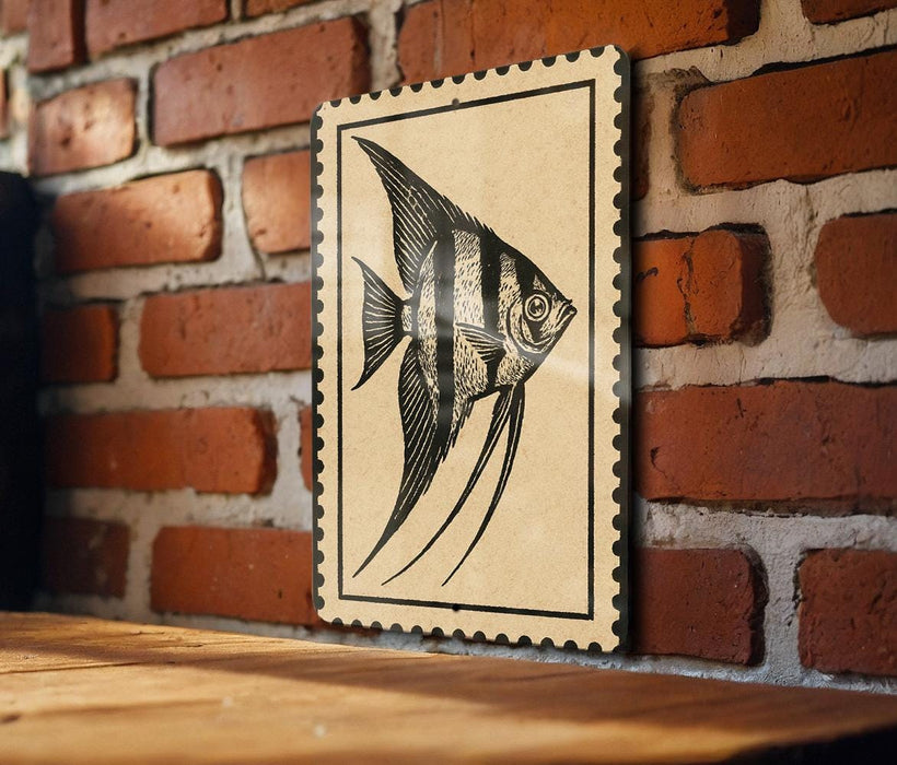 a framed illustration of a fish, specifically an angelfish, displayed on a brick wall.