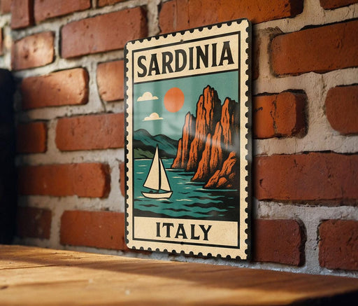 A vintage-style metal sign with a sailboat and mountains in the background, mounted on a brick wall.