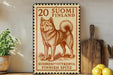 a wooden sign with a picture of a dog, a stamp, and some kitchen utensils on a shelf.