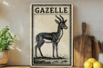 a decorative metal sign with a black and white illustration of a gazelle, placed on a wooden surface next to a wooden cutting board and some lemons.