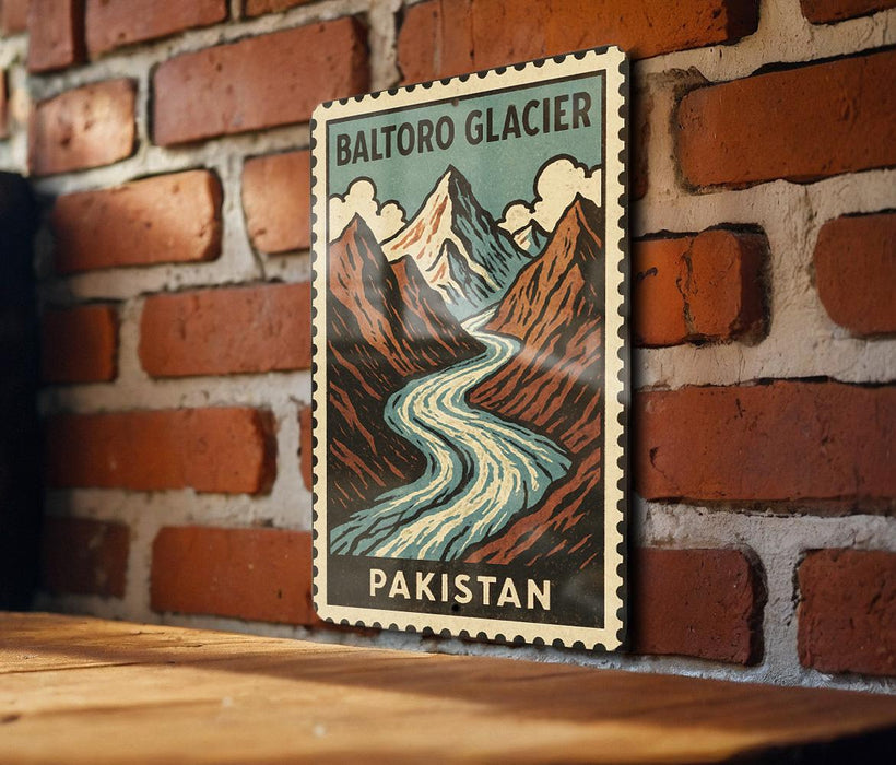 A vintage postage stamp featuring a mountain landscape with a winding river, mounted on a brick wall.