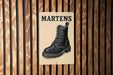A sign with the word "MARTENS" written on it, featuring an illustration of a black leather boot.