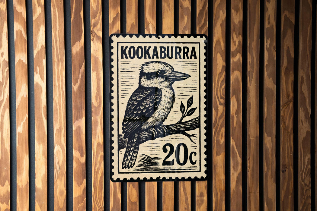 A postage stamp featuring a kookaburra, a type of bird, on a branch.