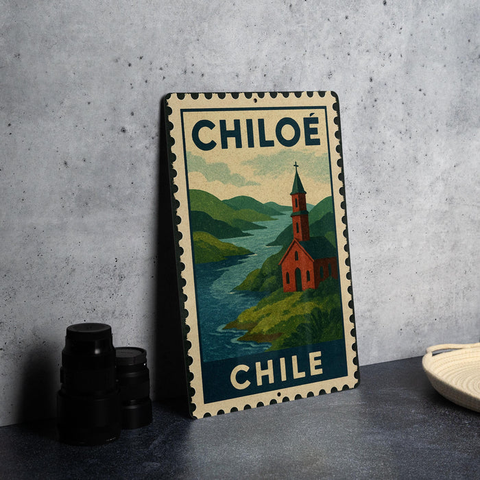 A metal sign with a vintage-style illustration of a church and a river, along with the text "CHILE" and "CHILE" written on it.