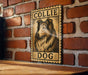 A wooden table with a framed poster of a collie dog on it, mounted on a brick wall.