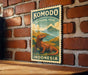 A vintage-style poster of Komodo National Park in Indonesia, featuring a large illustration of a Komodo dragon against a scenic landscape.