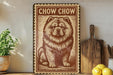 a vintage-style metal sign with a chow chow dog illustration, placed on a wooden surface next to a wooden cutting board and a potted plant.