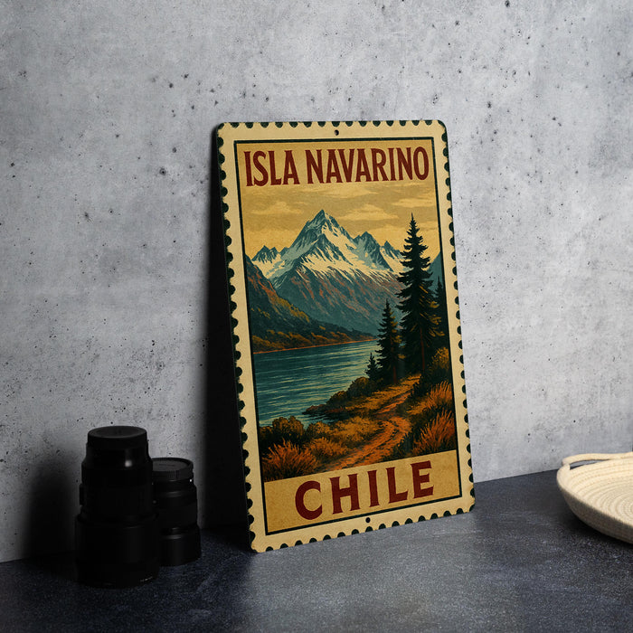 A vintage-style metal sign with the text "ISLA NAVARINO CHILE" printed on it, depicting a scenic mountain landscape with a lake and pine trees.