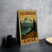 A vintage-style metal sign with the text "ISLA NAVARINO CHILE" printed on it, depicting a scenic mountain landscape with a lake and pine trees.