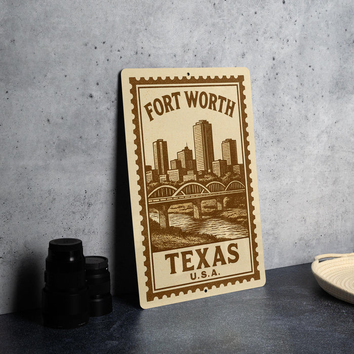 A metal sign with a cityscape and a bridge, featuring the text "Fort Worth, TX, U.S.A."