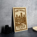 A metal sign with a cityscape and a bridge, featuring the text "Fort Worth, TX, U.S.A."