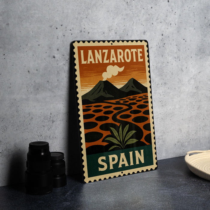 A vintage-style metal sign with the text "LANZAROTE SPAN" and an illustration of a landscape with mountains and a cloud.