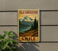 A vintage-style metal sign with a mountain landscape and a lake, mounted on a wall.