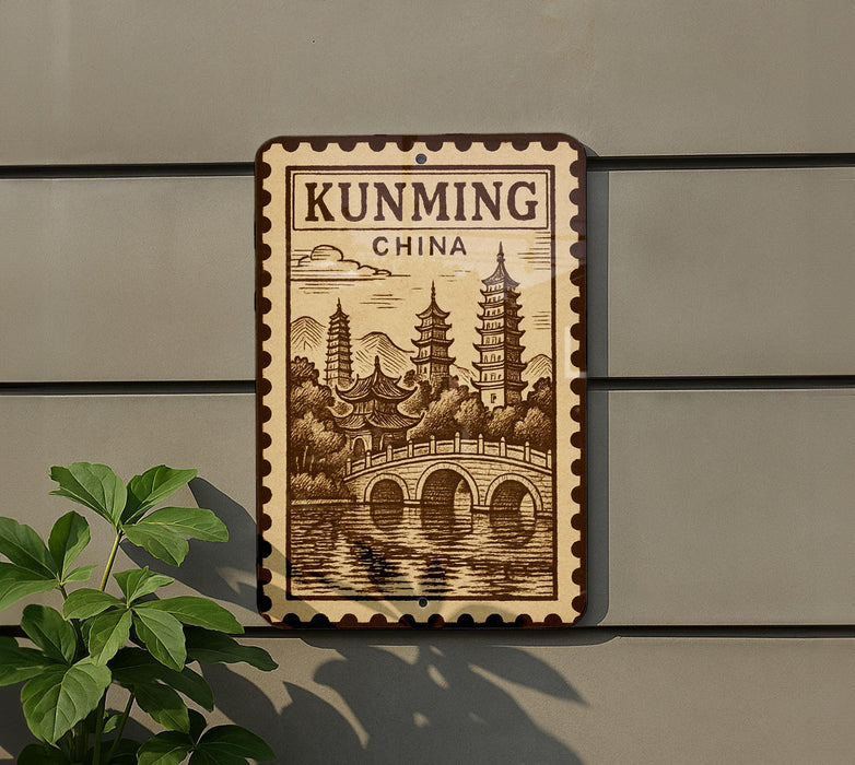 a sign that reads "KUNMING CHINA" with an illustration of pagodas and a bridge.
