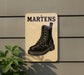 A sign with the word "MARTENS" written on it, featuring a black and white illustration of a boot.