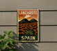 A vintage-style sign for Lanzarote, Spain, featuring a landscape with mountains, a palm tree, and a cloud-filled sky.