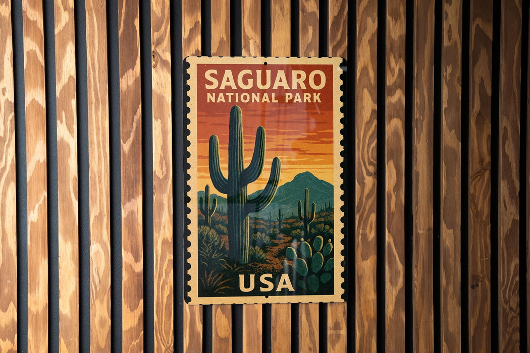 A vintage postage stamp featuring a cactus landscape and the text "SAGUARO NATIONAL PARK USA" is displayed on a wooden wall.