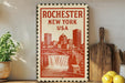 A vintage-style stamp depicting the city of Rochester, New York, USA, with a waterfall and buildings in the background.