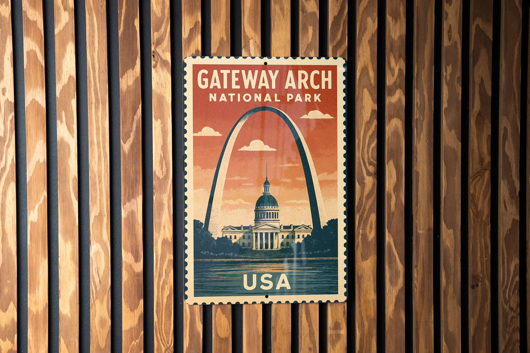 A vintage-style postage stamp featuring the Gateway Arch, a famous landmark in the United States, is displayed on a wooden wall.
