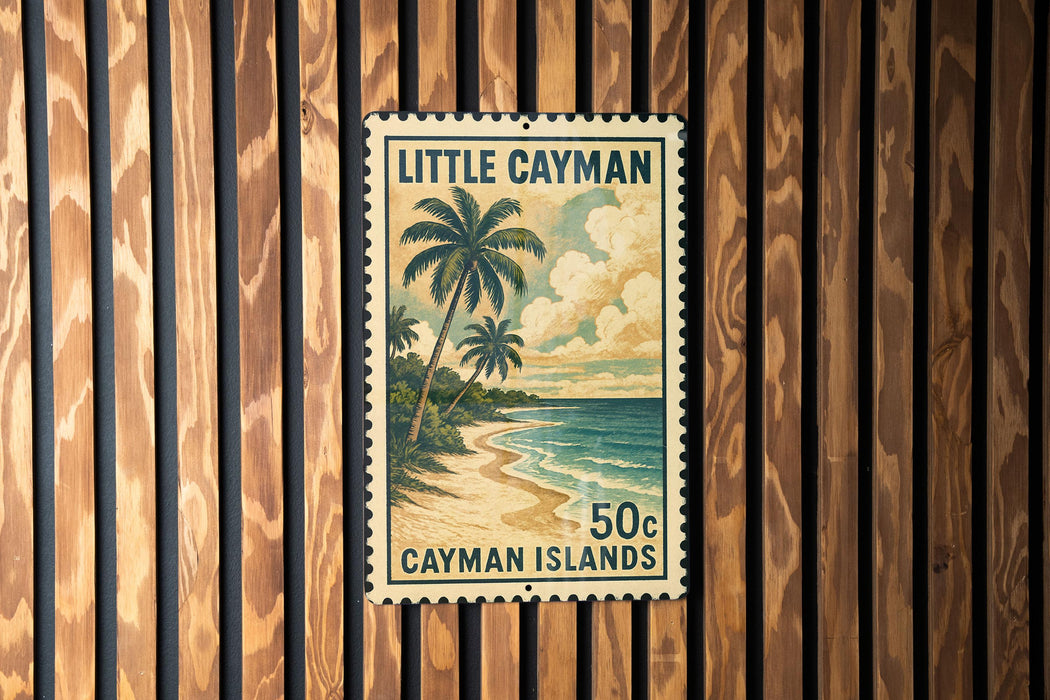 A vintage postage stamp from the Cayman Islands, featuring a tropical beach scene with palm trees and a cloudy sky.