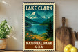 A framed poster of Lake Clark National Park in the United States, featuring a scenic mountain landscape with a lake and pine trees.
