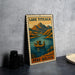 A vintage-style metal sign depicting Lake Titicaca in Peru, with a boat on the lake and mountains in the background.