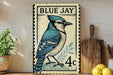 A vintage-style postage stamp featuring a blue jay, with the text "BLUE JAY 4c" printed on it. The stamp is displayed on a shelf next to a wooden cutting board and some potted plants.